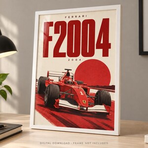 May include: A framed poster featuring a red Ferrari F2004 Formula One race car on a track. The design includes the text FERRARI F2004 2004 in bold red letters against a cream background, with a large red circle behind the car, mimicking a rising sun.