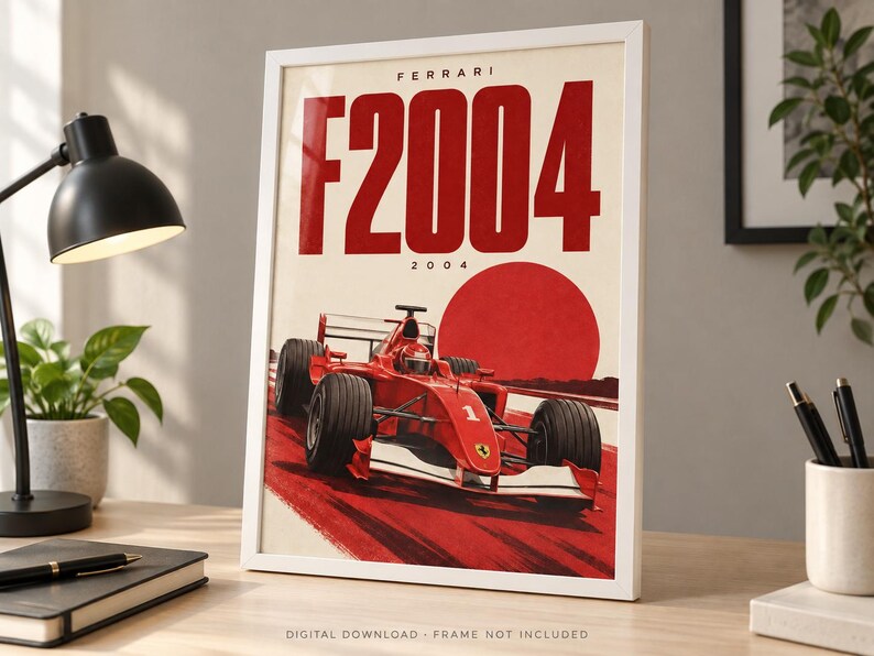 May include: A framed poster featuring a red Ferrari F2004 Formula One race car on a track. The design includes the text FERRARI F2004 2004 in bold red letters against a cream background, with a large red circle behind the car, mimicking a rising sun.
