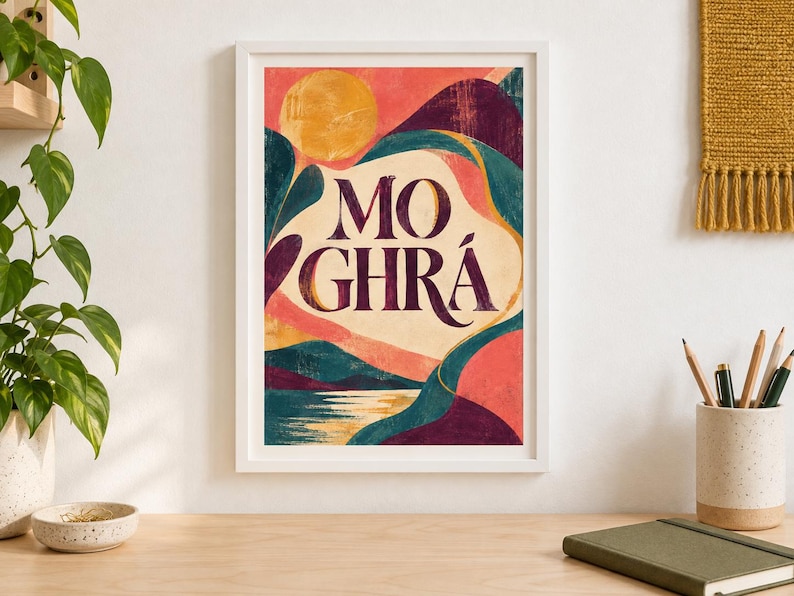 May include: A framed art print featuring a stylized landscape with a large yellow sun, rolling hills in shades of deep purple and teal, and a reflective body of water. The text MO GHR&Aacute; is centered in dark purple lettering against a cream background.