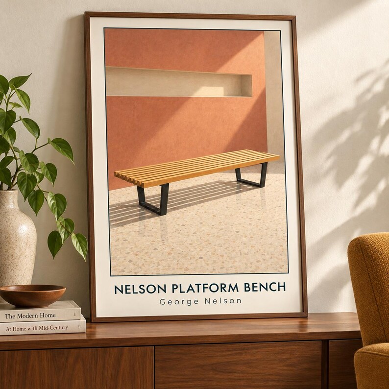 May include: A framed wall art print featuring a wooden slatted platform bench with black metal legs set against a terracotta wall. The text at the bottom reads NELSON PLATFORM BENCH George Nelson in a clean, black, sans-serif typeface.