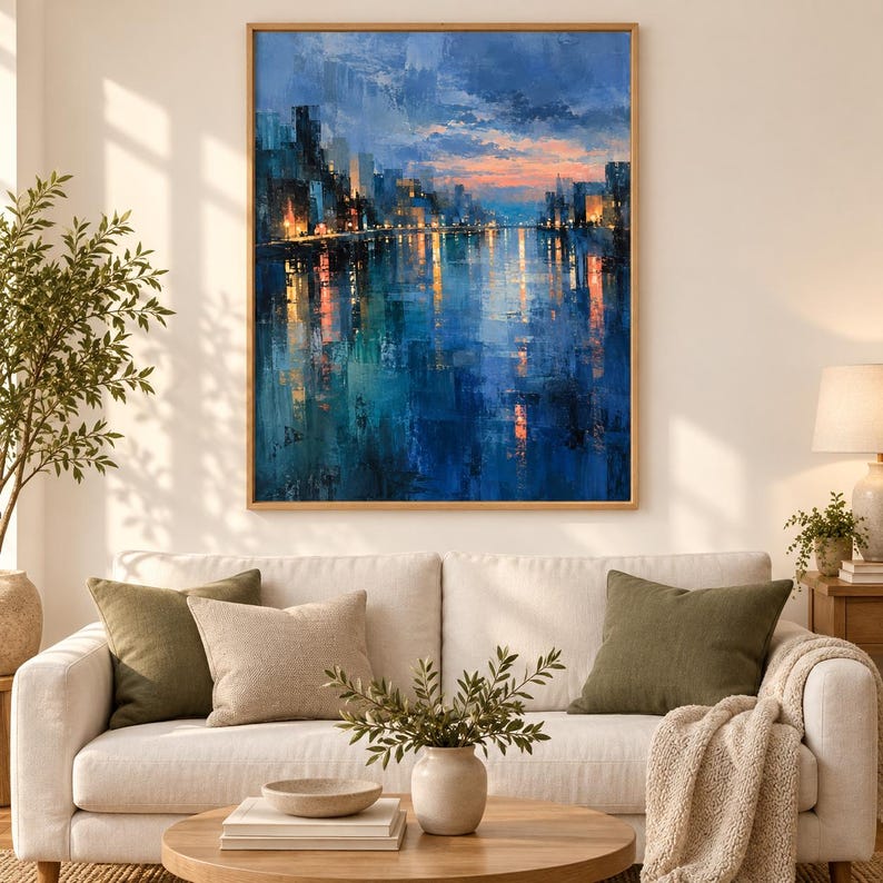 May include: A rectangular wall art painting depicting a city skyline at twilight with deep blue and teal tones reflecting on water, featuring warm orange and yellow light accents from buildings against a soft sunset sky with visible brushstrokes.