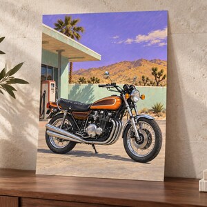 May include: A rectangular wall art print featuring a vintage orange and brown motorcycle parked in front of a desert gas station. The scene includes a turquoise building, a red gas pump, palm trees, and distant mountains under a purple sky.
