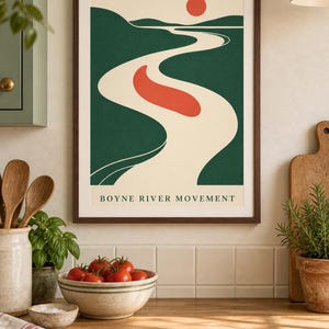 May include: A framed wall art print featuring a stylized landscape with a winding cream-colored river, dark green hills, a solid red sun, and a red oval shape in the center. The text BOYNE RIVER MOVEMENT is printed in black at the bottom of the print.