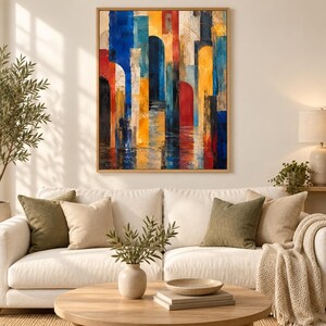 May include: A rectangular wall art piece featuring an abstract composition of vertical architectural arches in vibrant shades of blue, yellow, and red, set against a textured background with dark accents, framed in a light-toned wooden border.