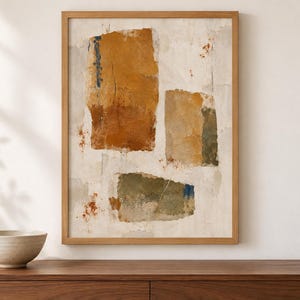 May include: A framed abstract wall art print featuring three distinct rectangular shapes in shades of ochre, muted green, and rust orange against a textured off-white background. The composition includes subtle blue accents and distressed paint effects.