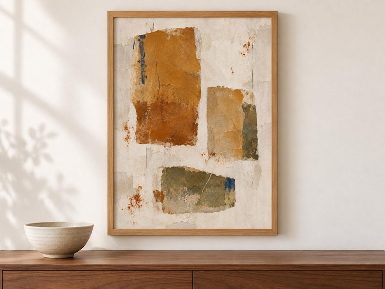 May include: A framed abstract wall art print featuring three distinct rectangular shapes in shades of ochre, muted green, and rust orange against a textured off-white background. The composition includes subtle blue accents and distressed paint effects.