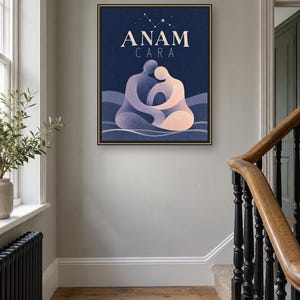May include: A framed rectangular wall art print featuring the text ANAM CARA in white capital letters. The illustration depicts two stylized figures in shades of blue and peach embracing against a dark blue background with a small star constellation.