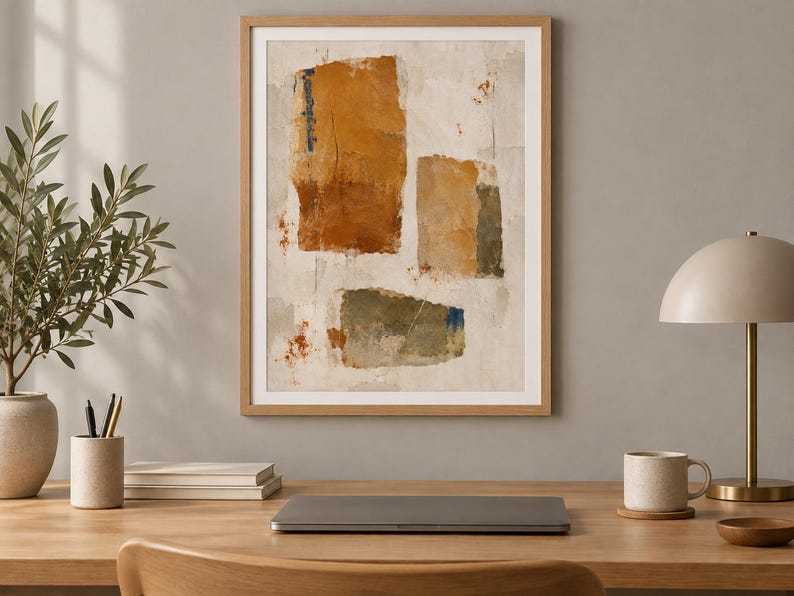 May include: A framed abstract wall art print featuring three distinct rectangular shapes in shades of burnt orange, muted olive green, and tan against a textured off-white background with subtle splatters of rust-coloured paint.