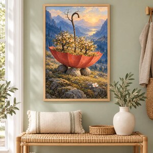 May include: A framed wall art print depicting a surreal landscape where a large red umbrella rests on rocky ground, containing small flowering trees and a wooden staff. The background features a mountain range under a golden sunrise sky.