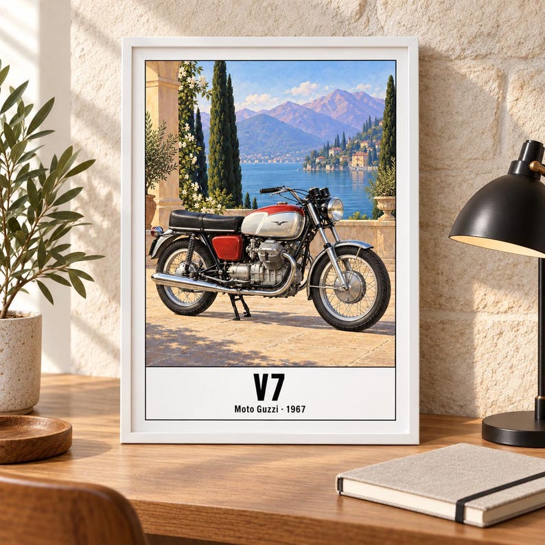 May include: A framed print featuring a 1967 Moto Guzzi V7 motorcycle parked on a stone terrace overlooking a lake and mountains. The motorcycle has a red and silver fuel tank and black seat. The text V7 Moto Guzzi 1967 is printed at the bottom.