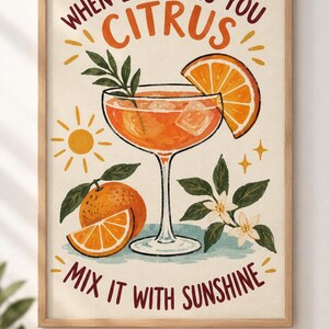 May include: A framed wall art print featuring a cocktail glass filled with orange liquid and ice, garnished with an orange slice. The text reads "WHEN LIFE GIVES YOU CITRUS" and "MIX IT WITH SUNSHINE" alongside illustrations of oranges, leaves, and a sun.