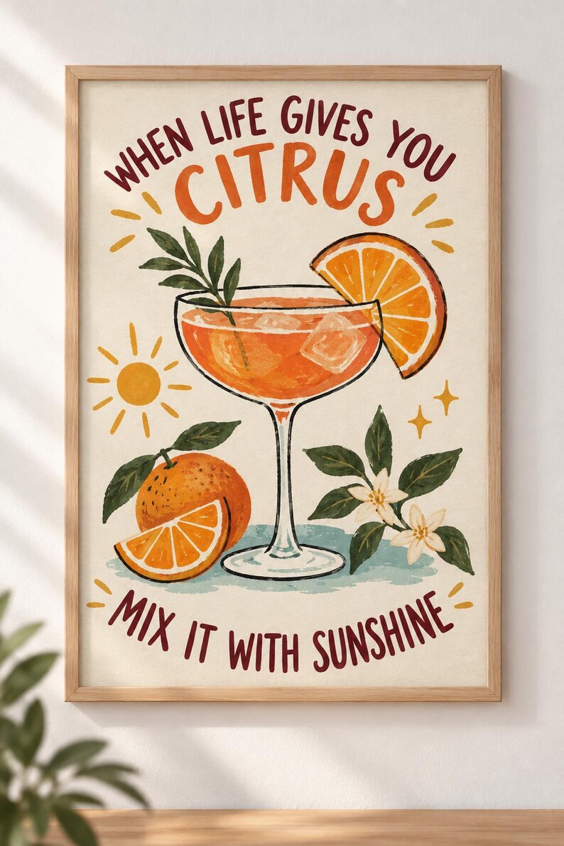 May include: A framed wall art print featuring a cocktail glass filled with orange liquid and ice, garnished with an orange slice. The text reads "WHEN LIFE GIVES YOU CITRUS" and "MIX IT WITH SUNSHINE" alongside illustrations of oranges, leaves, and a sun.