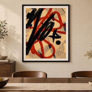 May include: A framed wall art print featuring bold, abstract brushstrokes in black and red layered over a beige background with a subtle, light gray checkered pattern. The composition includes thick, sweeping lines and a small black circular dot.