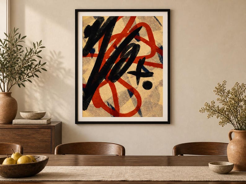 May include: A framed wall art print featuring bold, abstract brushstrokes in black and red layered over a beige background with a subtle, light gray checkered pattern. The composition includes thick, sweeping lines and a small black circular dot.