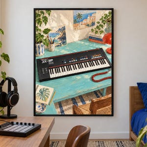 May include: A framed wall art print depicting a black Roland JX-3P synthesiser resting on a bright turquoise desk. The scene includes a red coiled cable, a potted plant, a small painting of a coastal landscape, and a stack of books on the desk.