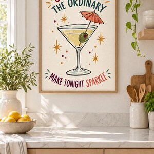 May include: A framed wall art print featuring a martini glass with an olive and a small red cocktail umbrella. The text reads SHAKE UP THE ORDINARY and MAKE TONIGHT SPARKLE, surrounded by yellow starbursts and small colorful dots on a cream background.