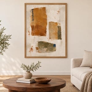 May include: A rectangular wall art piece in a light wood frame featuring an abstract composition of three distinct blocks of colour in shades of burnt orange, muted tan, and olive green against a textured, off-white, and cream-coloured background.