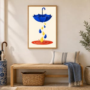 Pu&ograve; includere: Una stampa artistica da parete incorniciata che raffigura un ombrello blu sospeso in aria, con gocce di pioggia gialle e blu che cadono in una pozzanghera circolare rossa. L'opera &egrave; esposta in una cornice di legno chiaro su una parete neutra.