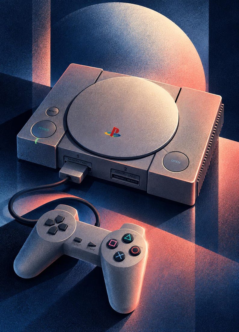 May include: A gray video game console with a circular disc cover featuring a multicolored PlayStation logo, two memory card slots, and a power button. A matching gray wired controller with black directional buttons and colored geometric symbols is connected.