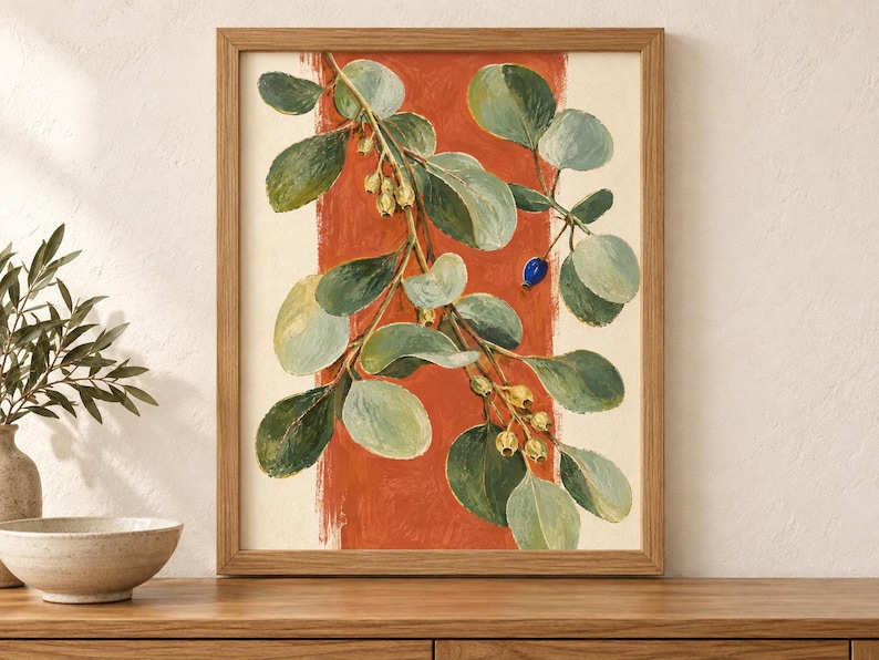 May include: A framed wall art print featuring a botanical illustration of a leafy branch with green foliage, small pale yellow buds, and a single bright blue berry. The branch is set against a vertical, textured terracotta orange stripe.