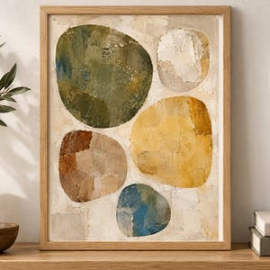 May include: A framed wall art print featuring an abstract composition of five large, rounded organic shapes in shades of olive green, mustard yellow, terracotta brown, muted blue, and off-white, set against a textured, cream-coloured background.