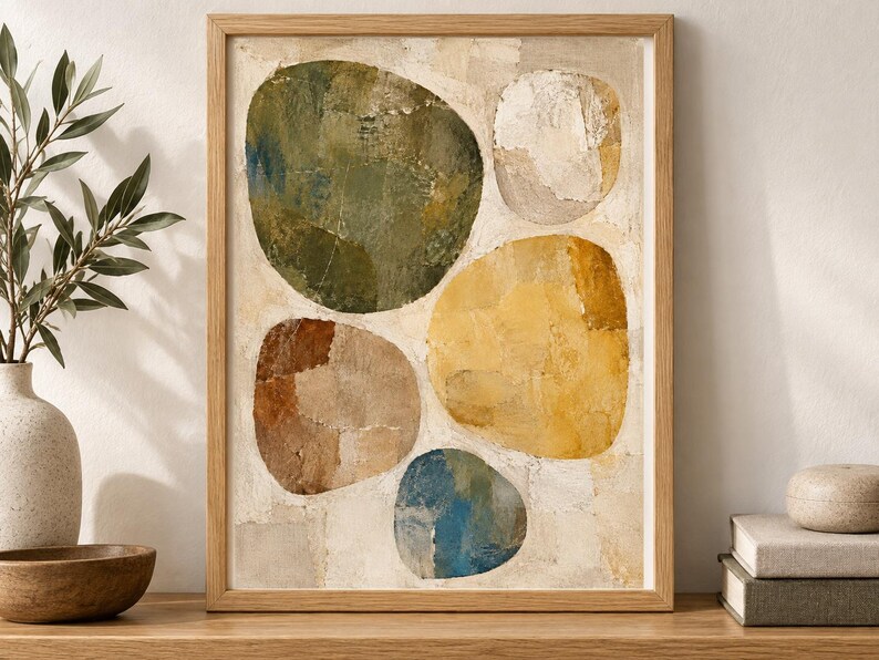 May include: A framed wall art print featuring an abstract composition of five large, rounded organic shapes in shades of olive green, mustard yellow, terracotta brown, muted blue, and off-white, set against a textured, cream-coloured background.