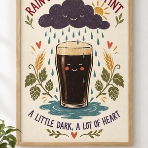 May include: A framed wall art print featuring a dark beer pint with a smiling face, surrounded by rain, a sun, and hops. The text reads: RAIN OR SHINE, HAVE A PINT and A LITTLE DARK, A LOT OF HEART. The illustration uses a cream background with red, blue, and green.