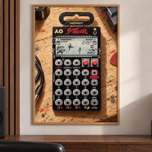 May include: A black Street Fighter themed pocket synthesiser featuring a digital display with game graphics, sixteen numbered buttons, two red knobs, and the text hadouken/ printed at the top. The device has a grid layout for sound, pattern, and drum controls.