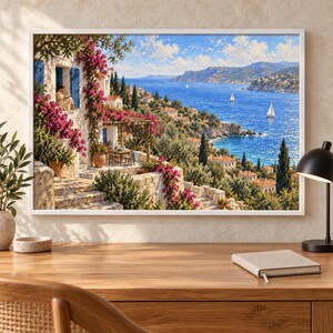 May include: A framed wall art print depicting a Mediterranean coastal scene with a white stone villa, vibrant pink bougainvillea flowers, a terrace with a table and chairs, and a blue sea with sailboats under a bright sky with scattered clouds.