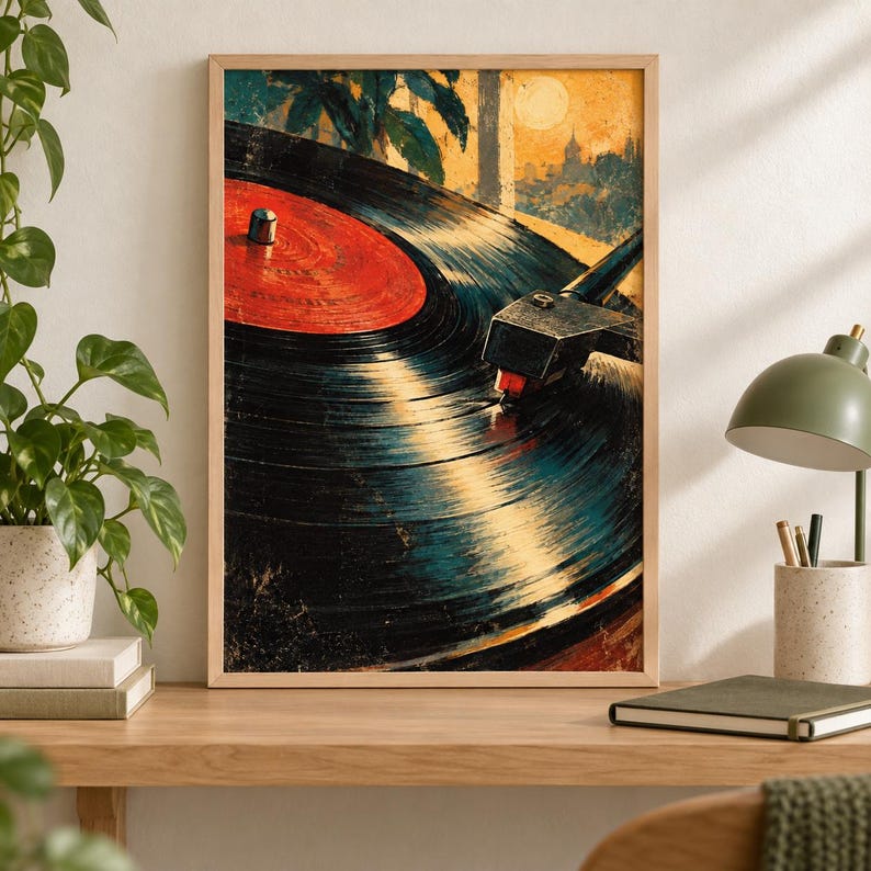 May include: A framed wall art print featuring a close-up illustration of a black vinyl record spinning on a turntable. The record has a vibrant red center label. The background depicts a stylized sunset landscape with silhouettes of trees and buildings.