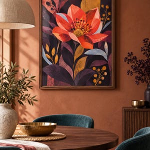 Op de afbeelding: Een rechthoekige wandkunstprint met een grote, gestileerde oranje en rode bloem als centraal punt. Het kunstwerk bevat donkerpaars en zwart gebladerte, met accenten van geel en lichtblauw, allemaal gevat in een eenvoudige houten lijst.