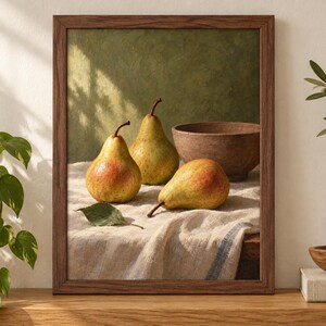 May include: A framed wall art print featuring a still life painting of three yellow and red pears and a brown bowl resting on a textured white cloth. The artwork is enclosed in a dark brown wooden frame, showcasing a green textured background.