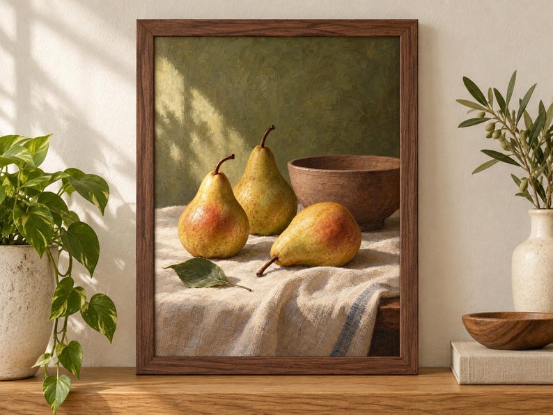 May include: A framed wall art print featuring a still life painting of three yellow and red pears and a brown bowl resting on a textured white cloth. The artwork is enclosed in a dark brown wooden frame, showcasing a green textured background.