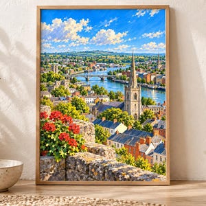 May include: A framed wall art print depicting a vibrant landscape of a town with a stone church spire, a river, and a bridge under a bright blue sky with white clouds. In the foreground, a stone wall is adorned with bright red geranium flowers.