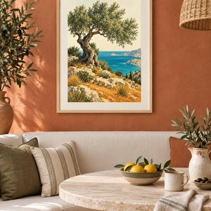 May include: A framed vertical wall art print depicting a coastal landscape with a gnarled olive tree on a rocky hillside overlooking a deep blue sea under a clear sky, featuring earthy tones of green, yellow, and blue in a light wood frame.
