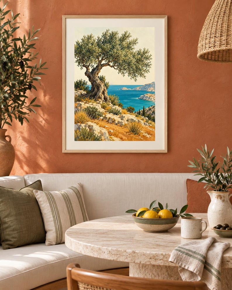 May include: A framed vertical wall art print depicting a coastal landscape with a gnarled olive tree on a rocky hillside overlooking a deep blue sea under a clear sky, featuring earthy tones of green, yellow, and blue in a light wood frame.
