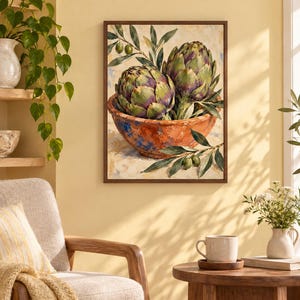May include: A rectangular framed wall art print featuring an oil painting of two green and purple artichokes resting in a rustic, textured terracotta-colored bowl, accented with green olive branches and leaves against a light, neutral background.