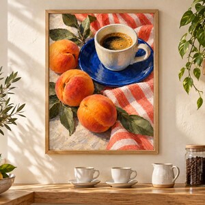 May include: A framed wall art print depicting a still life scene with three ripe orange peaches with green leaves resting on a white and orange striped cloth next to a white ceramic coffee cup placed on a vibrant blue saucer filled with black coffee.