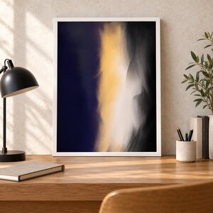 May include: A rectangular wall art print in a white frame featuring an abstract composition with a deep navy blue left side, a central vertical band of bright yellow, and a soft white and charcoal grey gradient on the right side.
