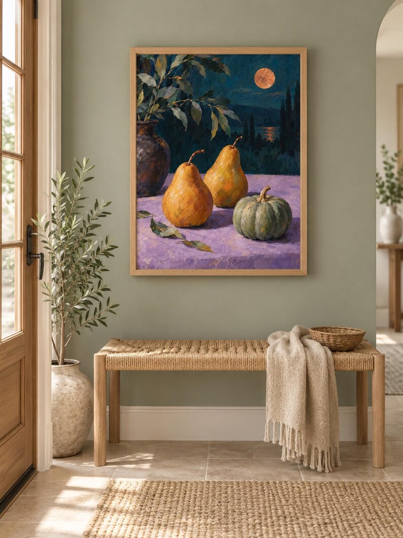 May include: A framed oil painting depicting two golden pears and a green pumpkin on a purple surface. The background shows a dark night landscape with a full moon, a body of water, and silhouettes of trees. The painting is enclosed in a light wood frame.