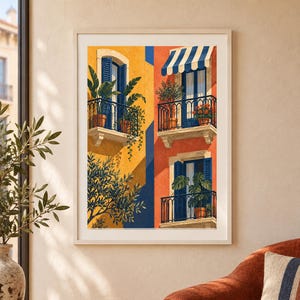 May include: A framed art print depicting a Mediterranean building facade with yellow and orange walls. The scene features three balconies with blue shutters, black railings, and potted plants. A striped blue and white awning covers one balcony.