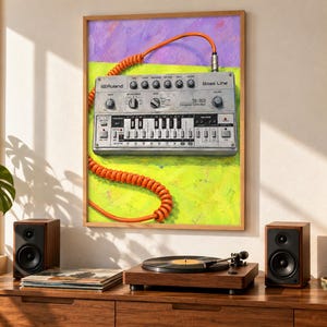May include: A framed wall art print featuring a silver Roland TB-303 Bass Line synthesizer with an orange coiled cable. The background is painted in vibrant lime green and purple brushstrokes, highlighting the iconic electronic music device.