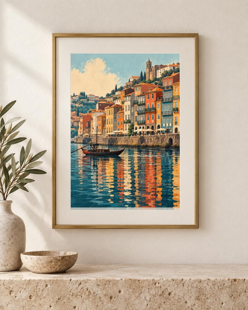 May include: A framed wall art print depicting a coastal town with colorful buildings in shades of orange, yellow, and blue along a stone embankment. A small wooden boat floats on the calm water, which reflects the vibrant architecture and blue sky.