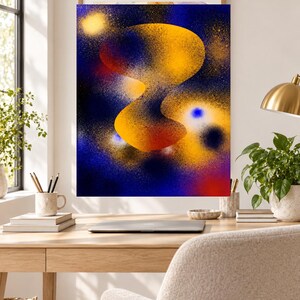 May include: A rectangular wall art print featuring an abstract composition with a central, fluid, golden-yellow organic shape set against a deep blue background. The design incorporates spray-painted textures, speckles, and vibrant orange and red accents.