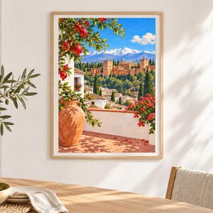 May include: A framed wall art print depicting a Mediterranean scene with a terracotta vase, a pomegranate tree, and a view of the Alhambra palace complex against a backdrop of snow-capped mountains under a bright blue sky with white clouds.
