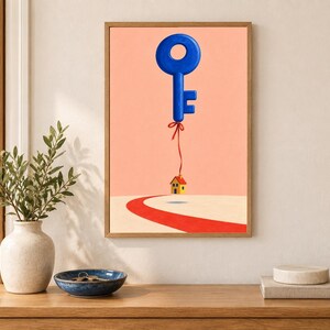 May include: A framed wall art print featuring a large blue key floating in a peach-colored sky, tethered by a thin red string to a small yellow house with a red roof that hovers slightly above a curved red path on a light beige ground.