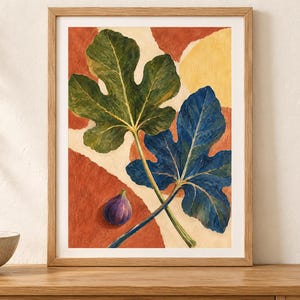 May include: A framed art print featuring a painting of two large fig leaves, one green and one deep blue, positioned over a background of abstract terracotta and cream shapes. A single small purple fig sits in the lower left corner of the composition.