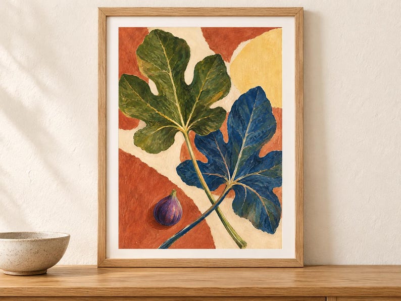 May include: A framed art print featuring a painting of two large fig leaves, one green and one deep blue, positioned over a background of abstract terracotta and cream shapes. A single small purple fig sits in the lower left corner of the composition.