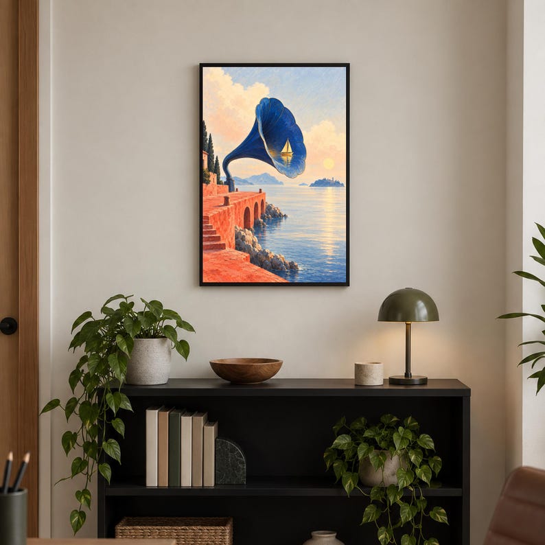 May include: A framed wall art print featuring a surreal landscape with a large blue gramophone horn overlooking a calm sea at sunset. A small white sailboat is visible inside the horn, set against a backdrop of orange cliffs and a distant island.
