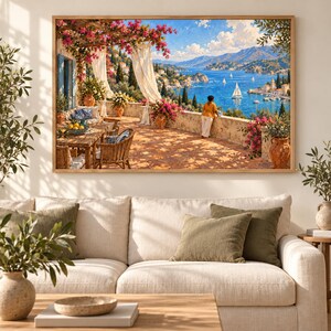 May include: A rectangular wall art print depicting a sunlit Mediterranean terrace with a stone floor, wicker furniture, and pink bougainvillea flowers. A person stands by a stone wall overlooking a blue bay with sailboats and distant mountains.
